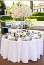 Table decoration with white flowers for guests in an outdoor restaurant Royalty Free Stock Photo