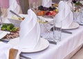 Table decorations, napkin folded in a pyramid, glasses, dishes,