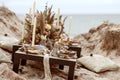 A table designed for a boho style event with an eucalyptus, vintage plates and other rustic touches. Royalty Free Stock Photo