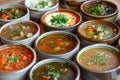 A table displayed with a diverse assortment of soups and stews, An assortment of soups and stews Royalty Free Stock Photo