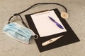 Table doctor, thermometer, stethoscope, mask, ballpoint pen, tablet for writing