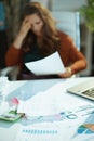 Table with documents in green office and woman with document Royalty Free Stock Photo