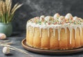 On the table, an Easter cake is positioned, encircled by eggs and wheat, with a traditional Ukrainian pattern visible in Royalty Free Stock Photo