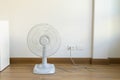 Table electric fan sit on the wooden floor Royalty Free Stock Photo