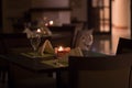 A table at a fancy restaurant candle light romantic dinner setting dim lighting Royalty Free Stock Photo