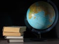 On the table a few books and one globe. Royalty Free Stock Photo