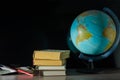 On the table a few books and one globe. Royalty Free Stock Photo