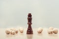 on the table is a figure of a black chess king. around which lie the pawns Royalty Free Stock Photo