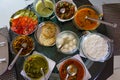 Table filled with fresh homemade gujarati food is seen from above. Traditional indian vegetarian kathiyawadi thali Royalty Free Stock Photo