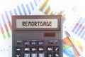 On the table are financial charts and a calculator, on the electronic board of which is written the text - REMORTGAGE