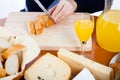 Table with food and female hands cutting bread