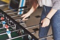 Table football in the entertainment center. Beautiful girl playing football Royalty Free Stock Photo