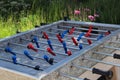 Table football stands outdoors. Foosball table stands at the public place