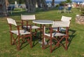 Table and four chair in the garden with green lawn grass Royalty Free Stock Photo