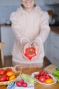 Age woman holding a large ripe tomato in her hands Royalty Free Stock Photo
