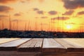 table in front of abstract blurred yachts at sunset Royalty Free Stock Photo