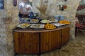 A table with fruit and sweet snacks stands in a corner in a roadside restaurant near the city of Wadi Musa in Jordan