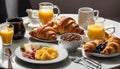 A table full of breakfast foods, including croissants, fruit, and orange juice Royalty Free Stock Photo