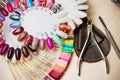 Table full of manicure utensils, manicure tools, nail polish colours on palette. Nails art accessories. Top view Royalty Free Stock Photo