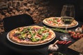 Table full of pizzas in restaurant. Italian cuisine. Dark theme