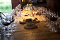 Table full of wine glasses filled with red wine and cheese plater
