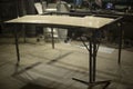 Table in garage. Production details. Metal frame of table in factory premises