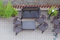 Table and garden chair from above . Sunny patio with table and chairs, high angle view Royalty Free Stock Photo