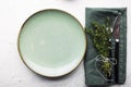 Table gentle simple serving in shades of green with a bunch of thyme on a light background. Top view. Royalty Free Stock Photo