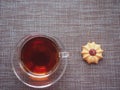 On the table is a glass Cup of tea and there is a huge amount