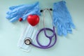 On table are gloves protective mask, a stethoscope and test for delivery for analysis Royalty Free Stock Photo