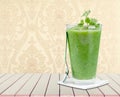 Healthy green smoothie in glass and spoon