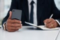 Table, hands and businessman with phone and notebook for planning, schedule or work agenda. Office, writing and a Royalty Free Stock Photo