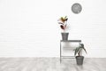 Table and indoor plants at white brick wall. Trendy home interior decor Royalty Free Stock Photo