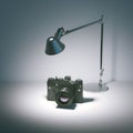 Table lamp illuminates a vintage photo camera