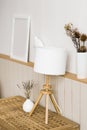 Table lamp, lavender in a white vase in the decor of the living room in a minimalist Scandinavian style. Mockup frame