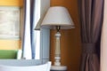 Table lamp with the mirror in a hotel room. Royalty Free Stock Photo