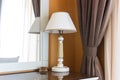 Table lamp with the mirror in a hotel room. Royalty Free Stock Photo