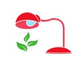 Table lamp warms a green plant