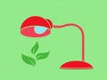 Table lamp warms a green plant