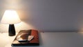 Table lamp with yellow light on a glass white table with a business folder with documents and money dollars and a smartphone Royalty Free Stock Photo