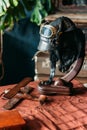 on the table lies the pilot's helmet, a toy airplane made of wood