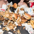 Table littered with an array of fast food. Fast Food waste concept. AI-generated.