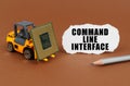 On the table, the loader transports the processor, next to it is paper with the inscription - Command Line Interface