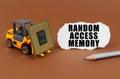 On the table, the loader transports the processor, next to it is paper with the inscription - Random Access Memory