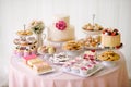 Table with loads of cakes, cupcakes, cookies and cakepops.