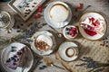 Table with loads of coffee, cakes, cupcakes, cookies, cakepops, desserts, fruits, flowers and croissants. Ancient spoons and a tra Royalty Free Stock Photo