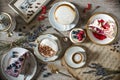 Table with loads of coffee, cakes, cupcakes, cookies, cakepops, desserts, fruits, flowers and croissants. Ancient spoons Royalty Free Stock Photo
