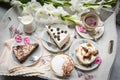 Table with loads of coffee, cakes, cupcakes, desserts, fruits, flowers and croissants. Royalty Free Stock Photo
