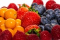 On a table are lying strawberries, bilberries, red currants, raspberries and blackberries Royalty Free Stock Photo