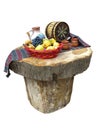 Table made of logs with fruit basket and wine barrel